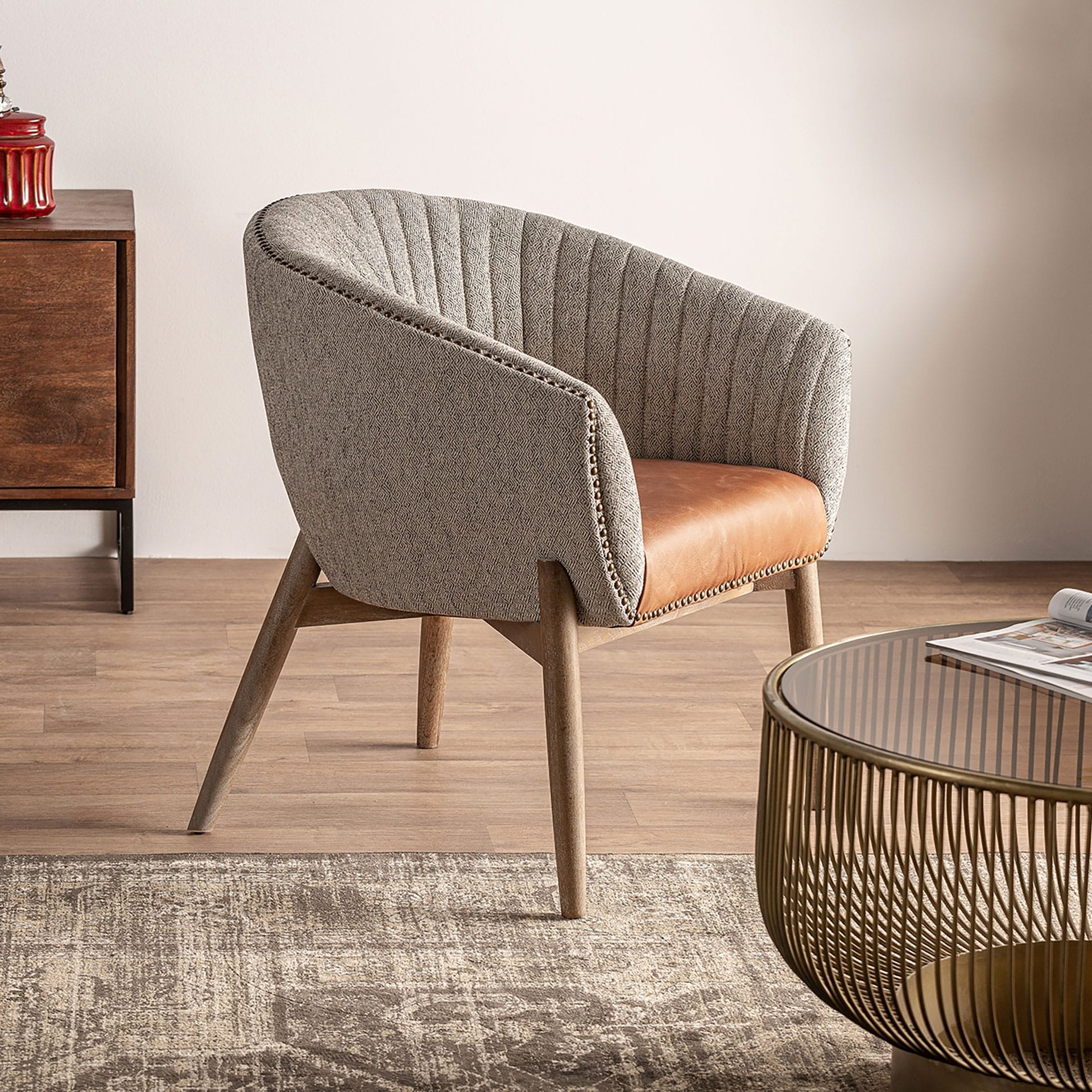 modern curved back armchair with grey fabric and brown leather seat
